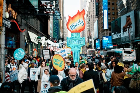 People attend a No Kings protest in Times Square in New York City on 18 October 2025.