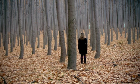 Woman standing in autumn forest
