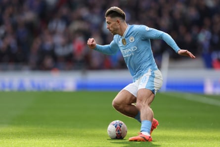 Jack Grealish runs with the ball for Manchester City