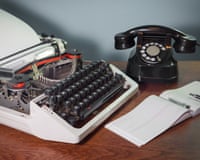 Retro typewriter and old telephone on the table, checkbook, ink pen