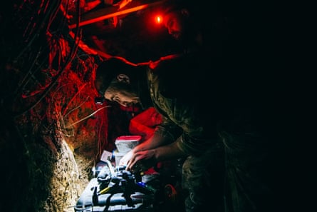 Drone operator Volodya, a police officer from the western city of Lviv, prepares the drop bomb before the mission.