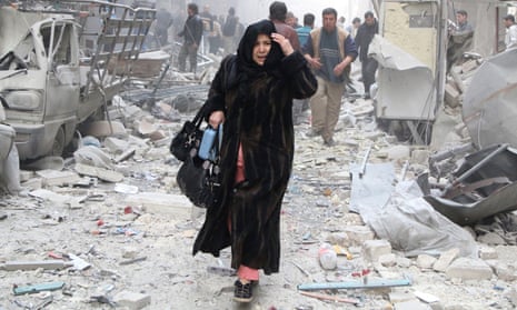 A woman reacts as she walks amid debris of damaged buildings at a site hit by what activists said was an air strike from forces loyal to Syria’s President Bashar al-Assad in Aleppo’s al-Shaar district March 18, 2014. REUTERS/Hosam Katan (SYRIA - Tags: POLITICS CIVIL UNREST CONFLICT) - RTR3HMUO