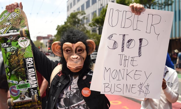 People protest near the Uber headquarters in San Francisco in on 8 May.