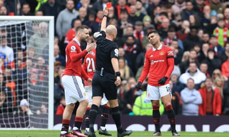 Anthony Taylor shows a red card to Casemiro during the first half at Old Trafford