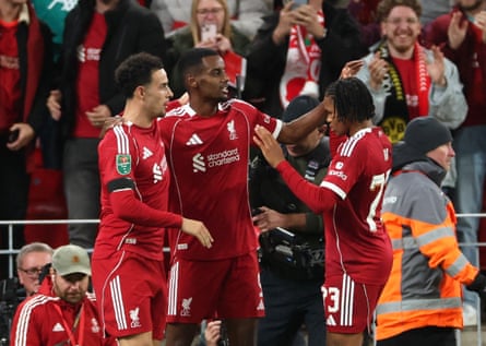 Alexander Isak celebrates scoring his first goal with Curtis Jones and Rio Ngumoha.