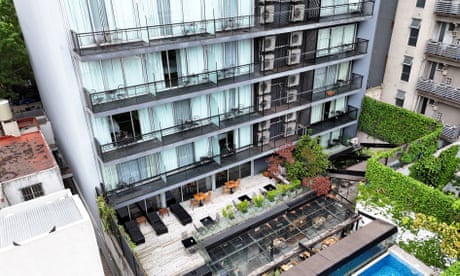 the outside of a multi-storey hotel with a pool deck