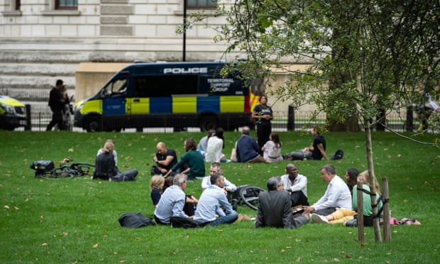 People socialise in St James’ Park, London.