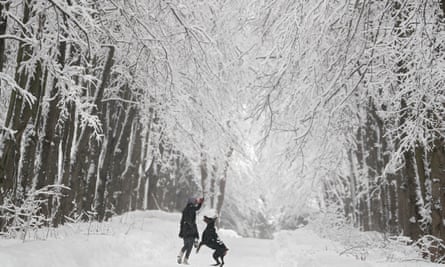 A woman plays with her dog in a park in Moscow, Russia, February 2019.