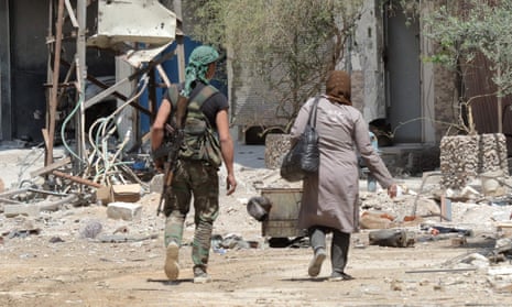 Syrian soldier walks with woman