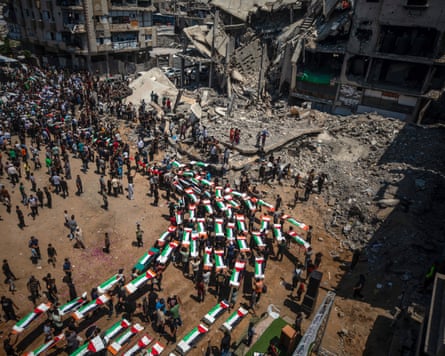Palestinians gather during a mass funeral