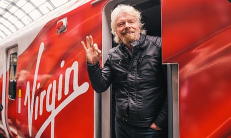 Sir Richard Branson pictured by a Virgin train