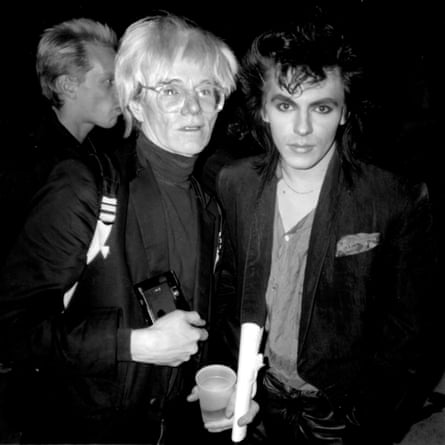 Andy Warhol and Nick Rhodes standing together looking at the camera