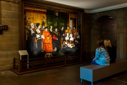 Visitors seated looking at Thomas More painting