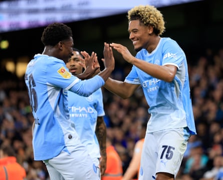 Ryan McAidoo congratulates Floyd Samba for scoring Manchester CityâÂÂs fourth goal against Norwich.