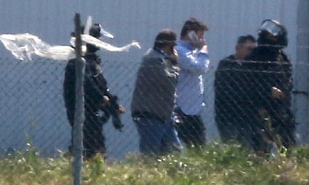 Passengers including Ben Innes are escorted away from the plane by police.