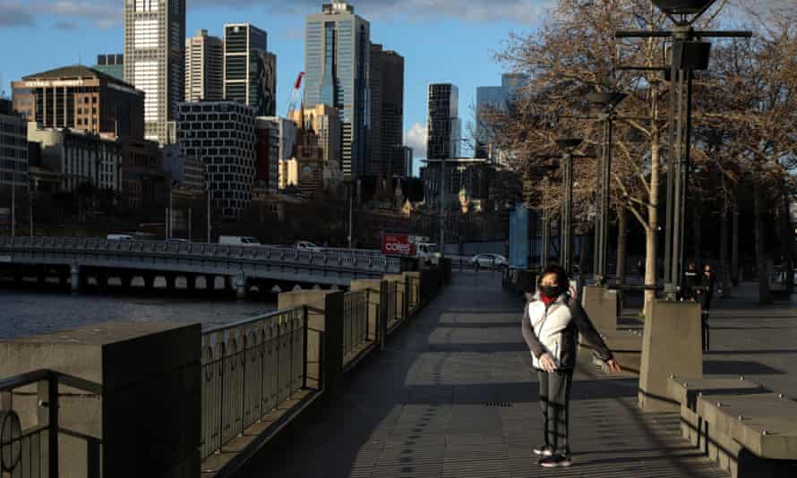 A woman carries exercises on the Yarra River in Melbourne during lockdown.