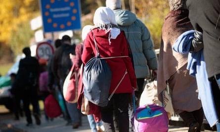 Migrants cross the Germany-Austria border.