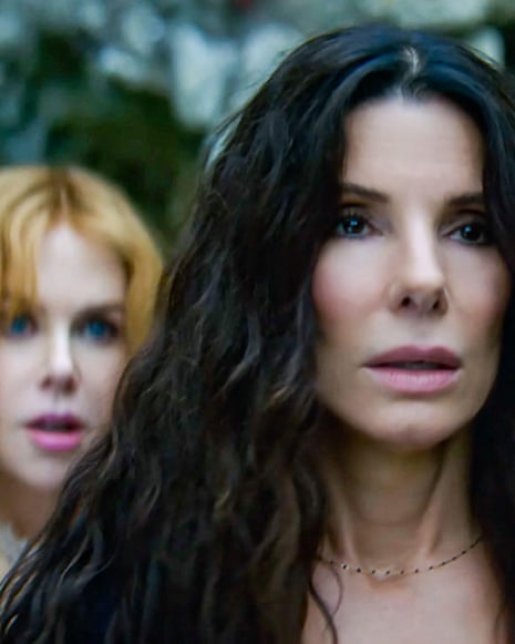 two women stand with surprised expressions