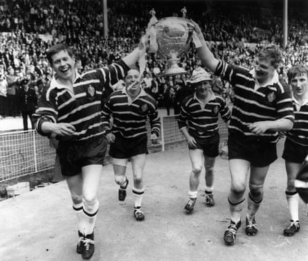 Featherstone Rovers’ captain, Malcolm Dixon (right) holds the Rugby League Cup with a teammate after they had beaten Barrow at Wembley in May 1967