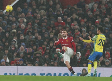 Shaw kicks the ball clear.