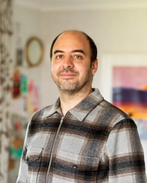 Andrzej Łukowski poses for a portrait in his living room.