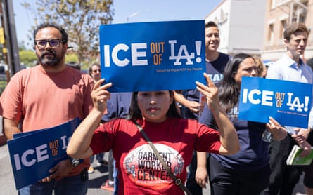 Protesters hold up signs