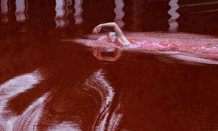 Lithuanian champion swimmer Rūta Meilutytė in the pond dyed red in front of the Russian embassy in Vilnius.