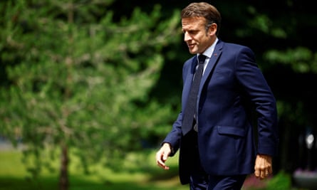 French president Emmanuel Macron in a blue suit taking a walk in June