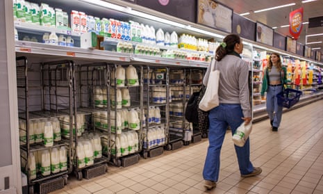 Customers shop for milk at Sainsbury’s supermarket in London,, 14 August.
