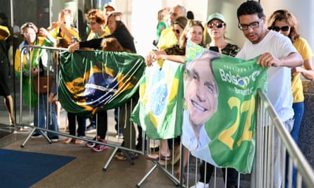 Supporters of Bolsonaro await his arrival at the Liberal party headquarters in Brasília on Thursday