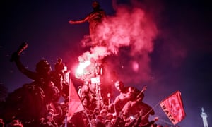 Protesters climb on The Triumph of the Republic statue at Place de la Nation in Paris during a demonstration against pension reforms.