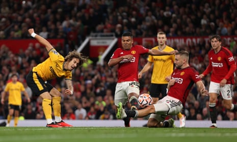 Fabio Silva of Wolverhampton Wanderers shot is blocked by Manchester United’s Luke Shaw.