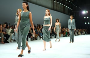 Models in olive green dresses, suits and two-pieces