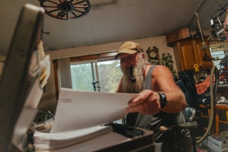 Ray Kemble, sorts through the hundreds of documents and photos chronicling the long fight against fracking in Dimock, PA.
