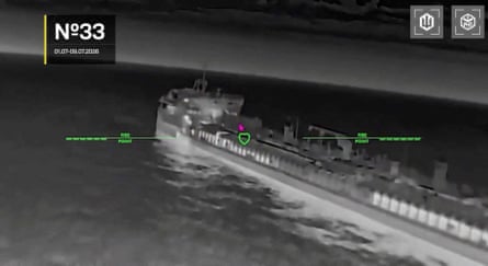 A night-vision shot of a tanker apparently being hit