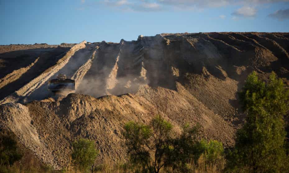 A large bulldozer works to move tailings pulled out of the Clermont coalmine in Queensland.