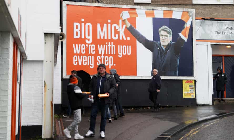 A billboard shows support for Mick Harford outside Luton’s Kenilworth Road stadium.