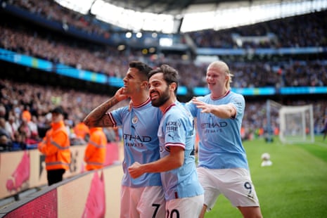 Joao Cancelo of Manchester City (left) celebrates with team-mates after scoring their team’s first goal.