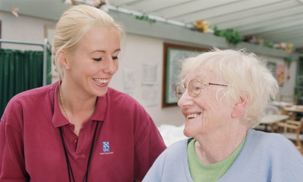 Female occupational therapist and elderly woman smiling during session to improve balance and stability in hospital