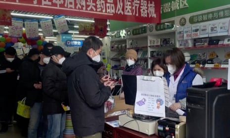 People stand in a queue to purchase medicines at a pharmacy in Beijing, China December 14, 2022, in this screen grab taken from a Reuters TV video. REUTERS TV via REUTERS