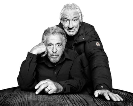 Al Pacino and Robert De Niro look towards the camera in puffer jackets
