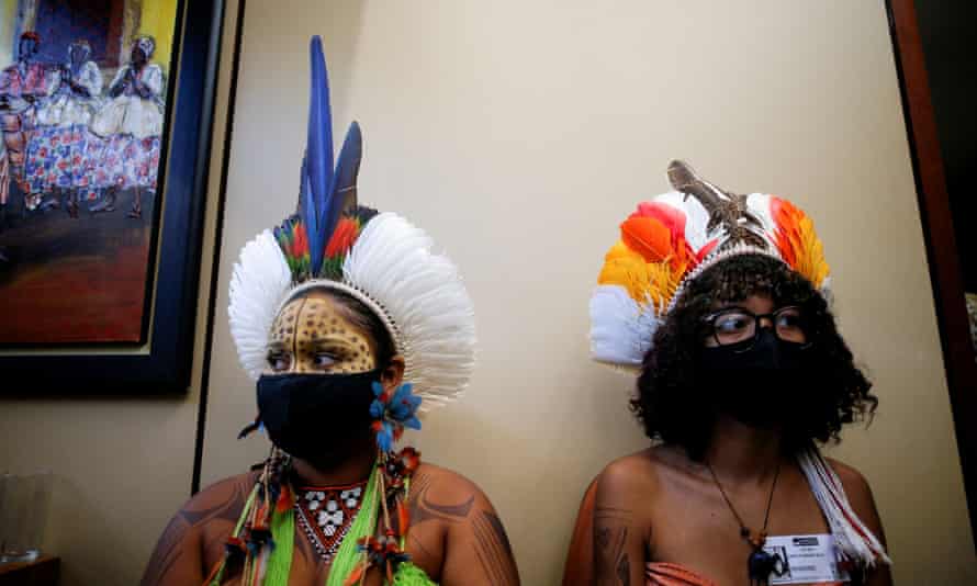 Indigenous people attend a meeting with members of congress in Brasília as they protest against President Jair Bolsonaro's policies that undermine their land rights.