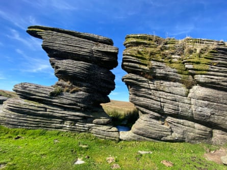 Two rocky outcrops against a bright blue sky