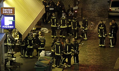 Police and rescuers outside a cafe in the 10th arrondissement of Paris on 13 November 2015, the night of the attacks.