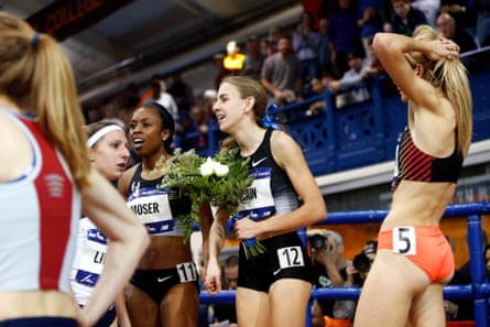 Mary Cain holds a bouquet of flowers as she stands with teammate and runner-up Treniere Moser during the Millrose Games in New York in 2014.