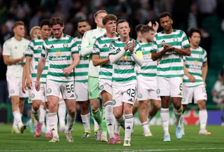 Callum McGregor leads the applause as Celtic players trudge round the pitch at full time