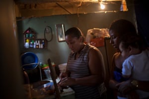 Taiana with her mother and child in the kitchen.