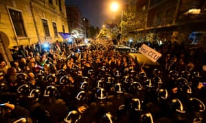 A march of the local demonstrators is blocked by riot police officers nearby the headquarter of the governor Fidesz party as students, teachers of the Central European University and their sympathisers protest in Budapest on 9 April.