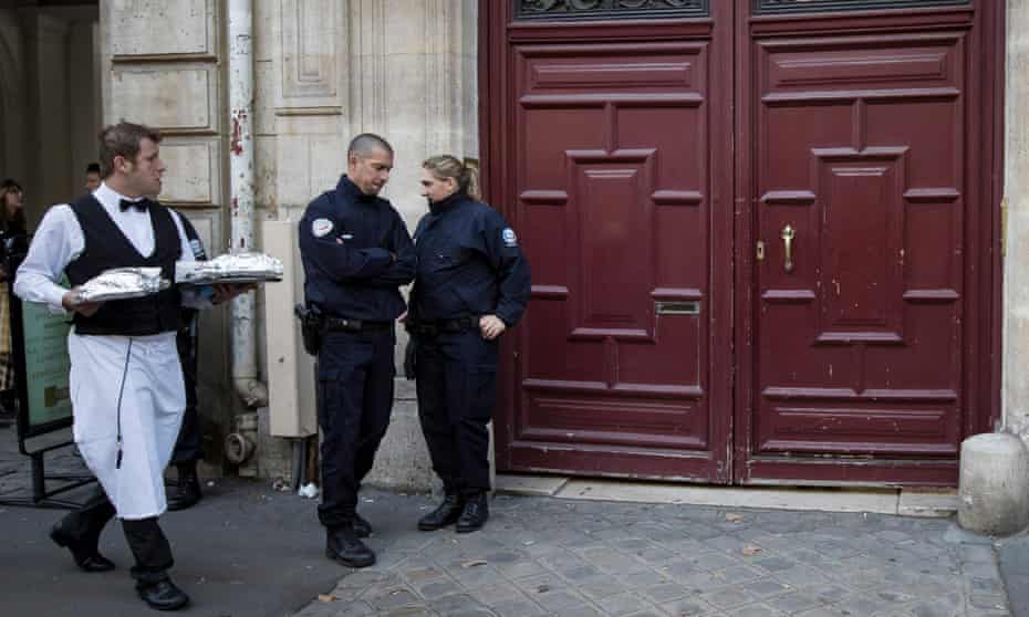French police stand guard outside one of the entrances to the Hôtel de Pourtalès