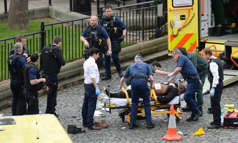The suspected attacker is treated by emergency services at the scene outside the Palace of Westminster.